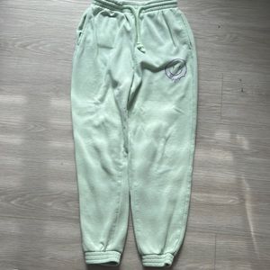 Green sweatpants with a purple smiley face, size XS in woman, from H&M